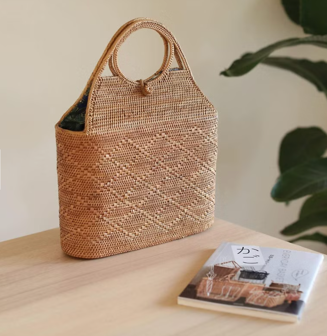 Chic rattan crossbody bag styled with a white blazer on a model.