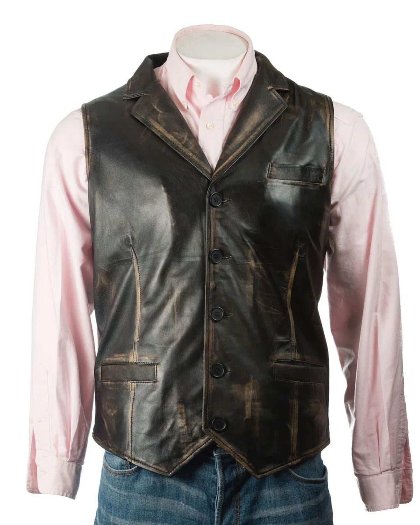 A stylish man wearing a black leather vest with silver buttons, paired with a white shirt and dark jeans, outdoors.