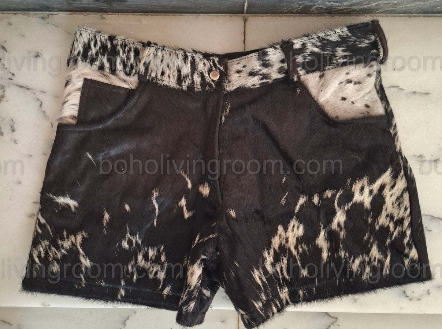 Real cowhide shorts for women featuring tricolor hair-on cow fur. Perfect for western wear, rodeo outfits, and bold cowgirl looks.