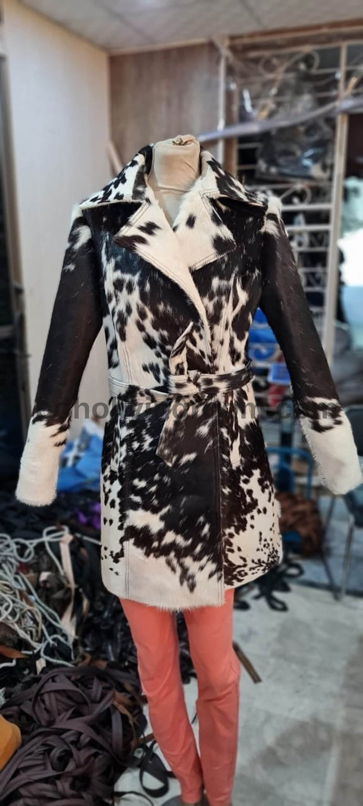 Stand out in a women cowhide trench coat with natural spotted hide pattern. Real cowhide leather jacket designed for bold winter styling.