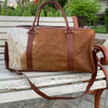 Experience luxury travel with this cow skin weekender bag, designed for your adventures.
