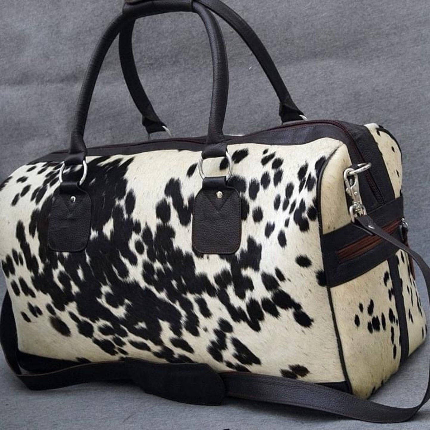 Step into sophistication with a sleek cow fur duffle bag, designed for the discerning traveler.
