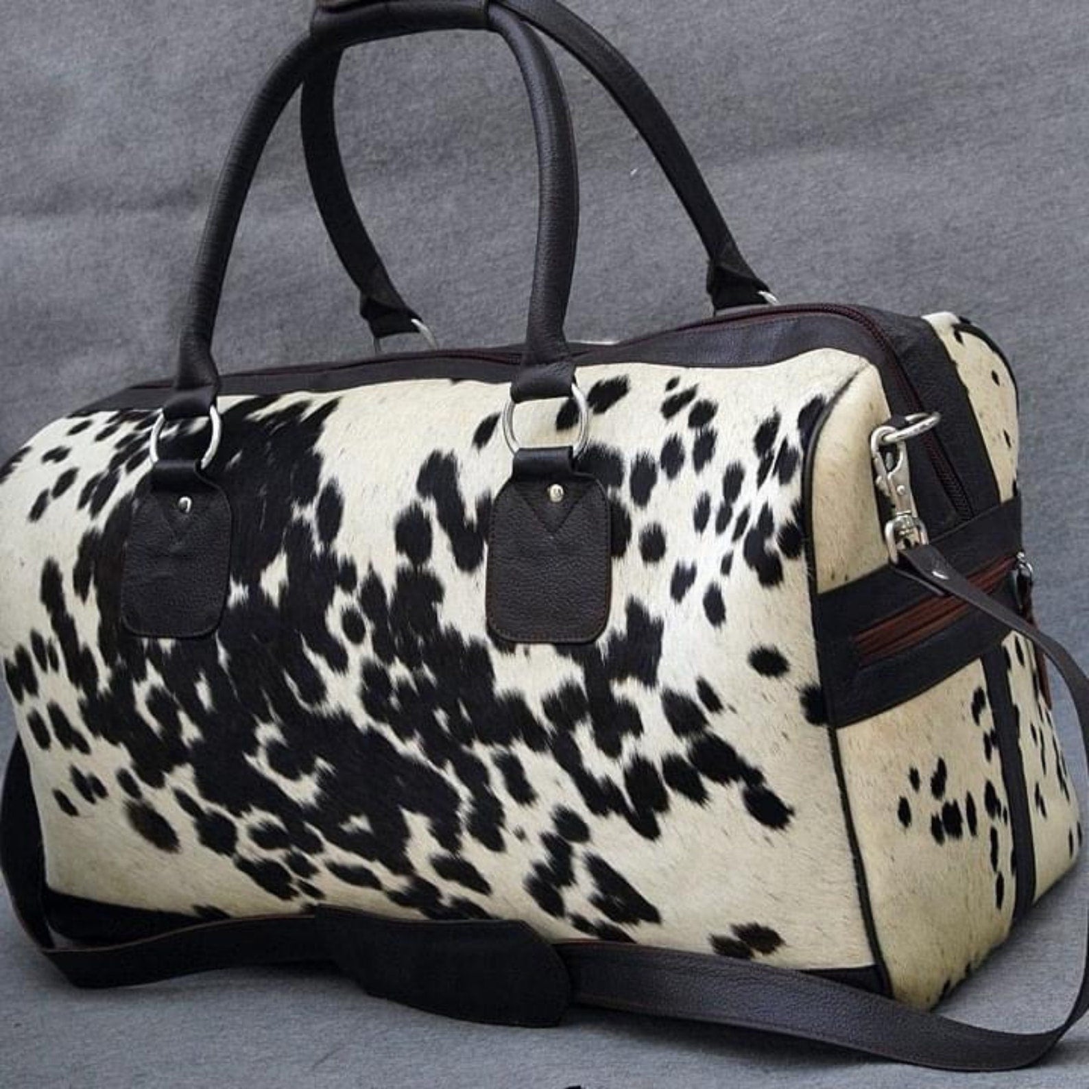 Step into sophistication with a sleek cow fur duffle bag, designed for the discerning traveler.