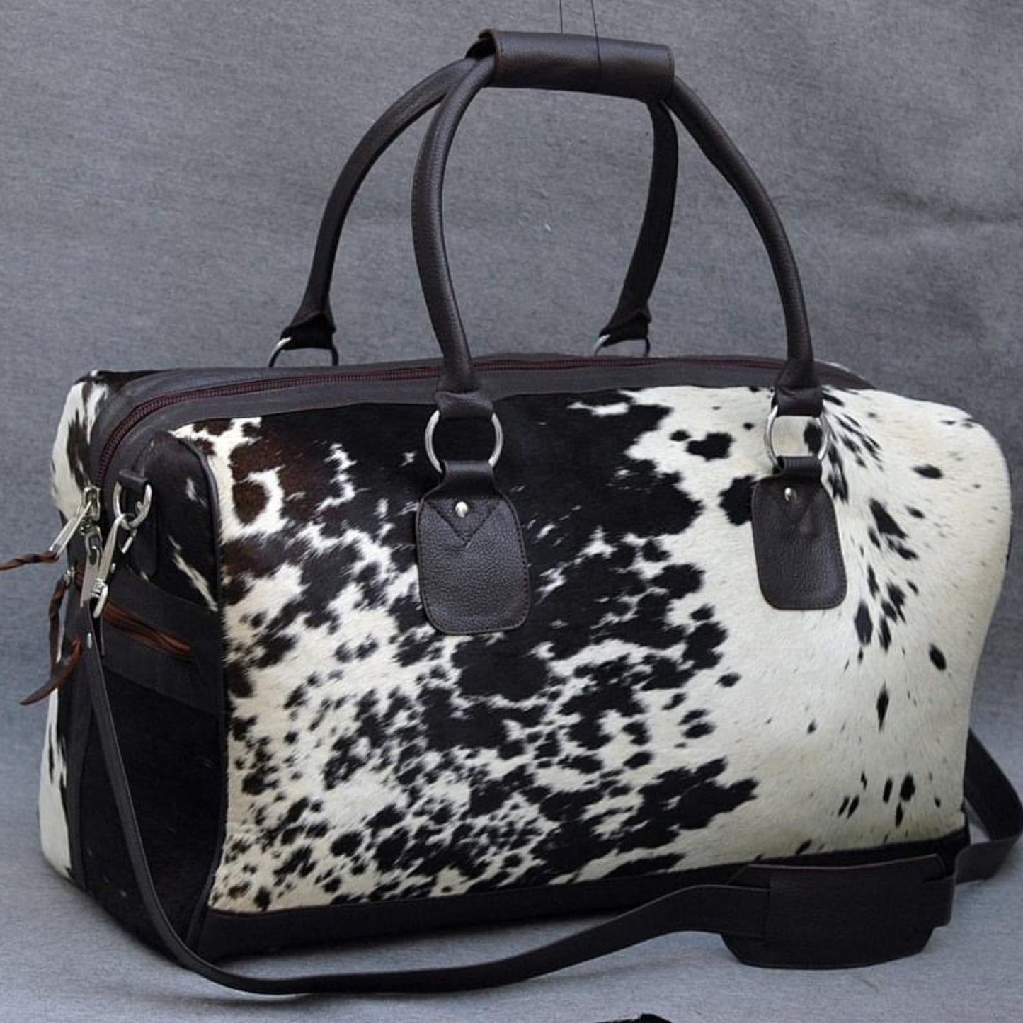 Travel in elegance with a timeless cow fur overnight bag, your essential companion for luxurious journeys.