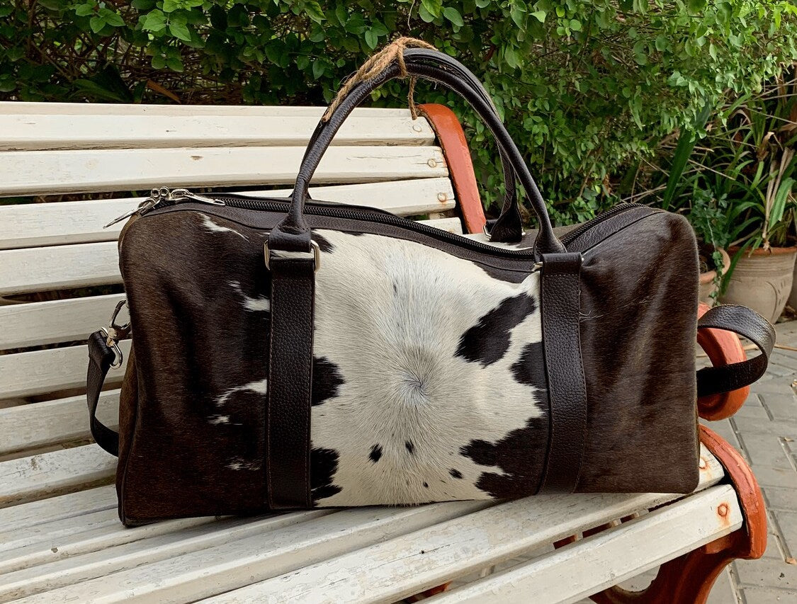 Hit the road in style with a chic cow fur weekender bag, a symbol of sophistication and adventure.