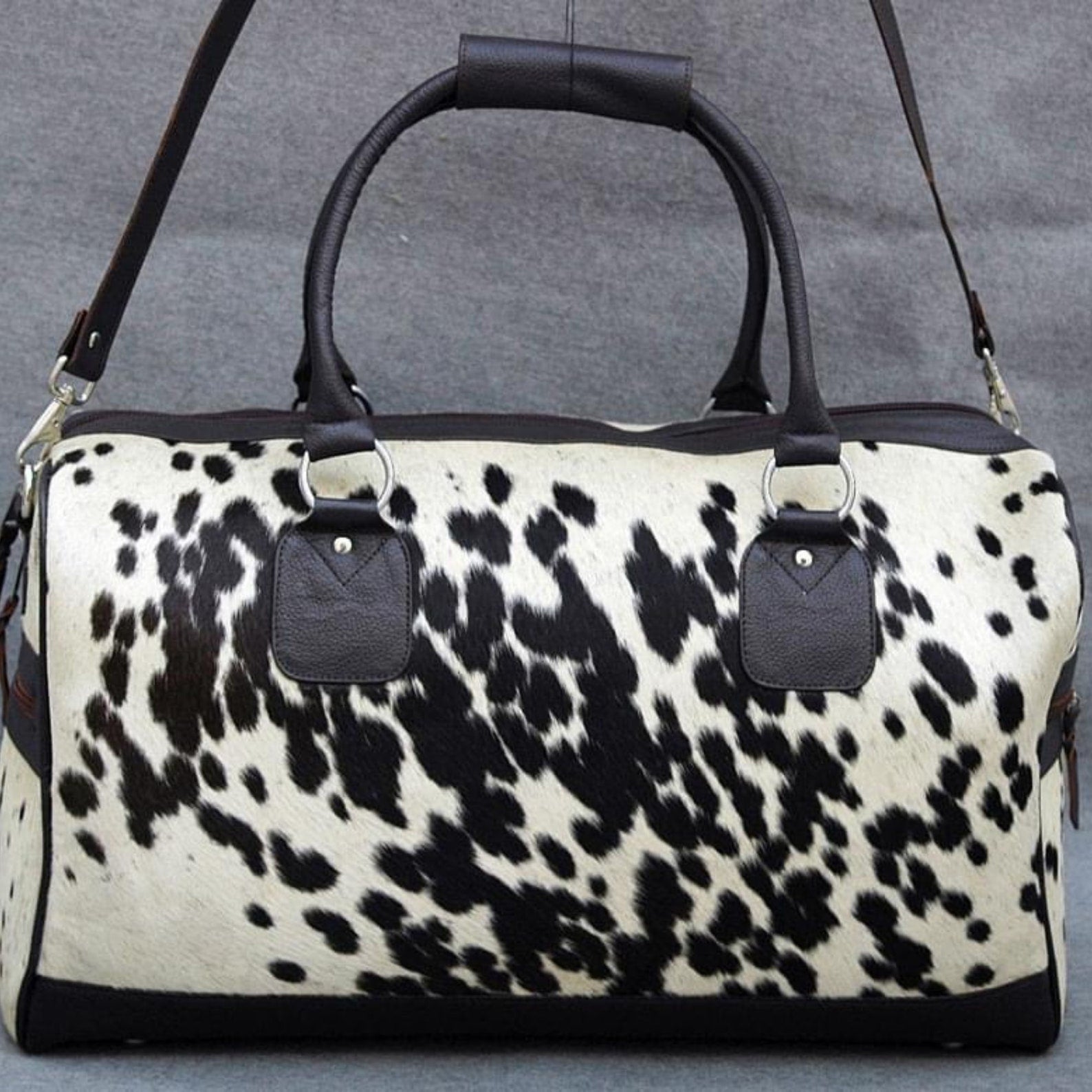 Embrace luxury travel with a sophisticated cow fur duffle bag, designed to complement your jet-setting lifestyle.