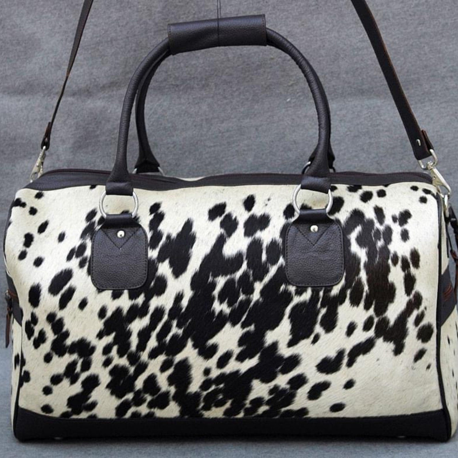 Travel in opulence with a refined cow fur overnight bag, your essential companion for indulgent adventures.