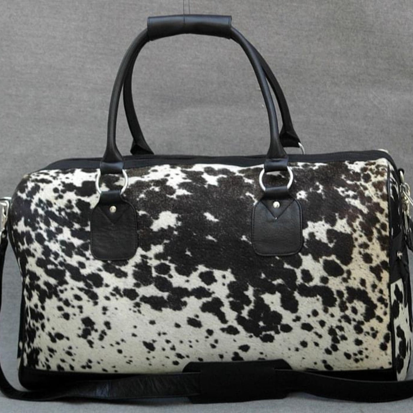 Experience the allure of exploration with a chic cow fur weekender bag, crafted for the modern traveler.