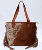 A western style cowhide purse for evening or weekend get away is the perfect accessory to take on any trip. This western-style, easy to carry bag will make any woman feel stylish and chic.