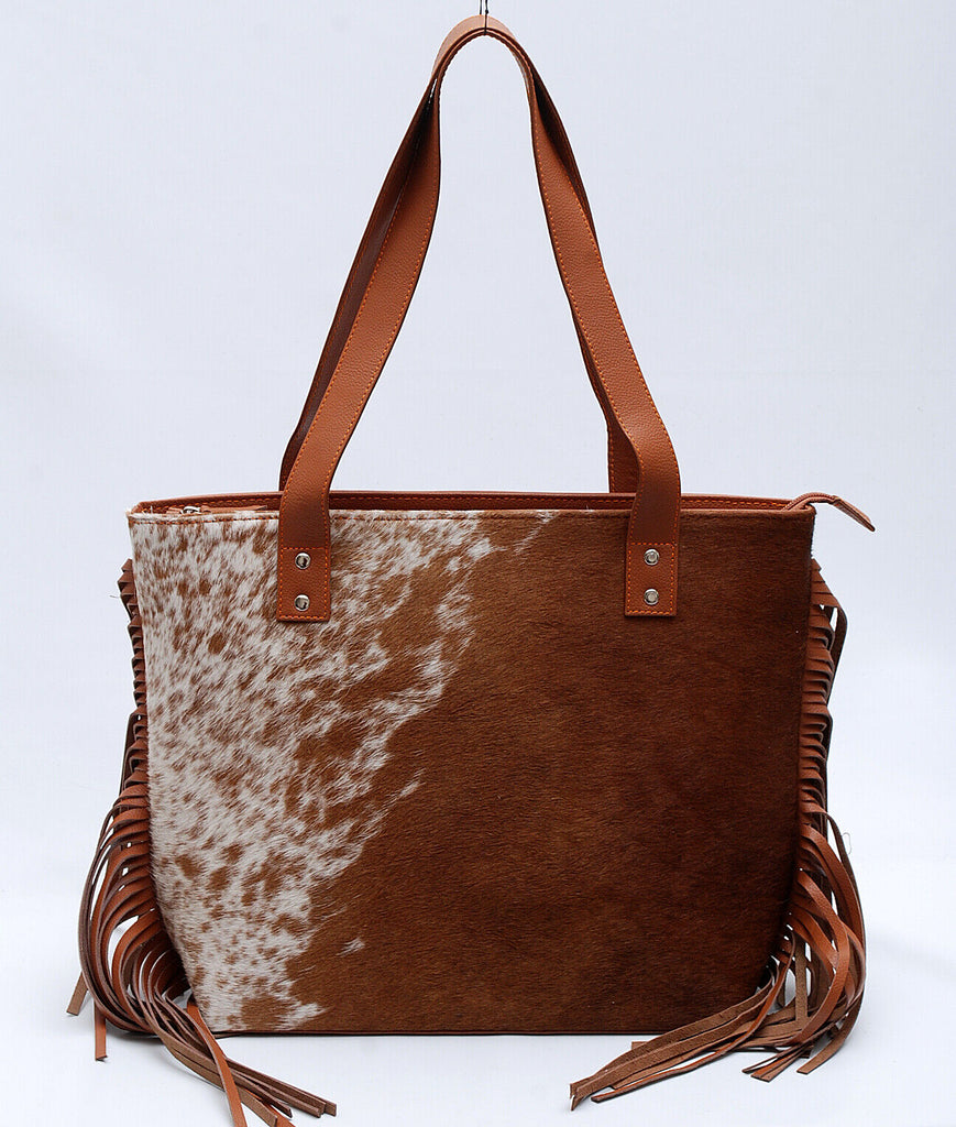 A western style cowhide purse for evening or weekend get away is the perfect accessory to take on any trip. This western-style, easy to carry bag will make any woman feel stylish and chic.
