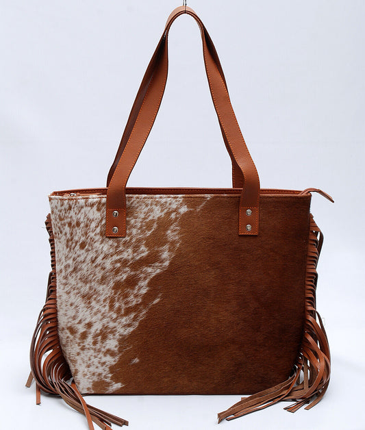 A western style cowhide purse for evening or weekend get away is the perfect accessory to take on any trip. This western-style, easy to carry bag will make any woman feel stylish and chic.
