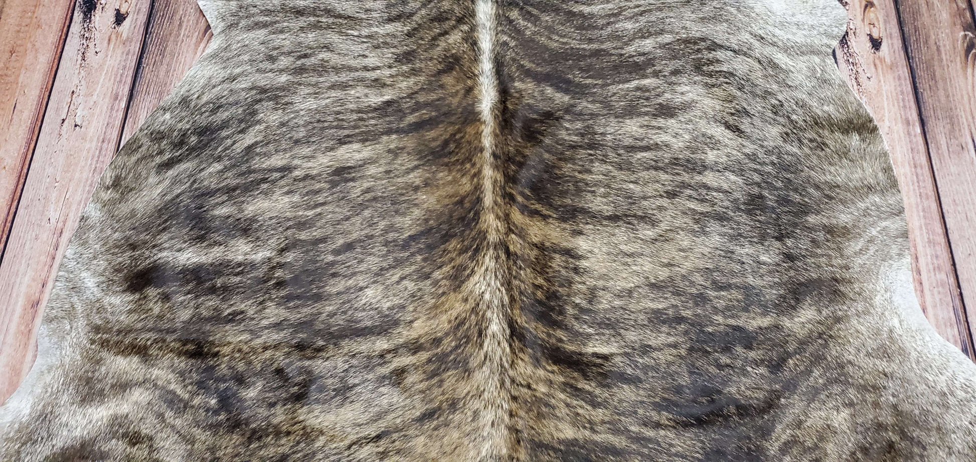 Solid grey brindle cowhide rug with a rustic look, its natural, real, chromium tanned, ethically sourced, hypoallergenic, very soft, smooth, hairs on, back finished to suede, no shedding, no curling and no strange smell. 