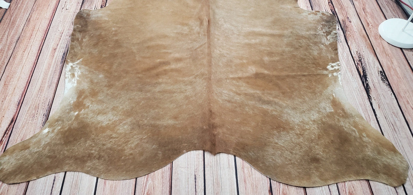 This beautiful light brown and beige cowhide rug is sure to add a stylish touch to any room in your home.