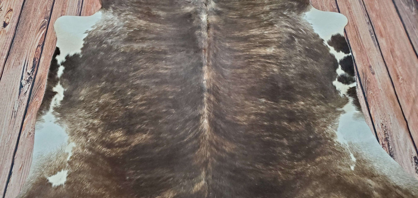 This luxurious black cowhide rug is perfect to add a touch of rustic charm to any room. Feel the soft texture beneath your feet and match it with any couch for maximum comfort.