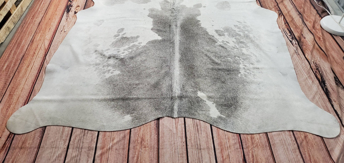 This luxurious cowhide rug grey white cowhide rug perfectly anywhere in the living room especially with brick wall theme.