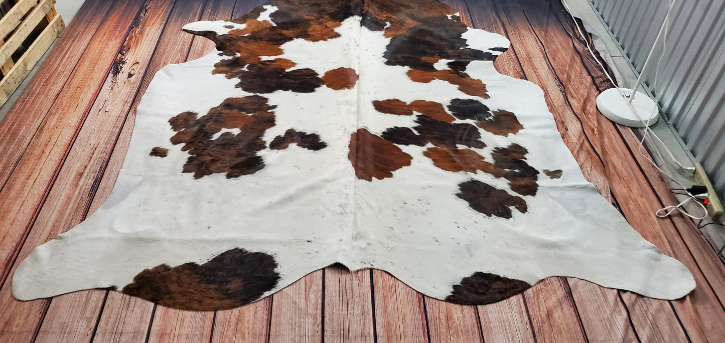 A modern cowhide rug with in dark brown, black and white like this is a great pick for a vast playroom, office space or crowded living room.