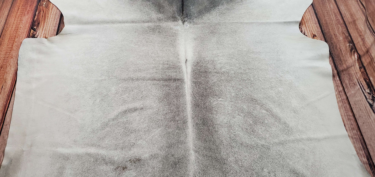 A stunning natural light grey cowhide rug that is soft, smooth and feels amazing underfoot, pliable enough to drape over any furniture.