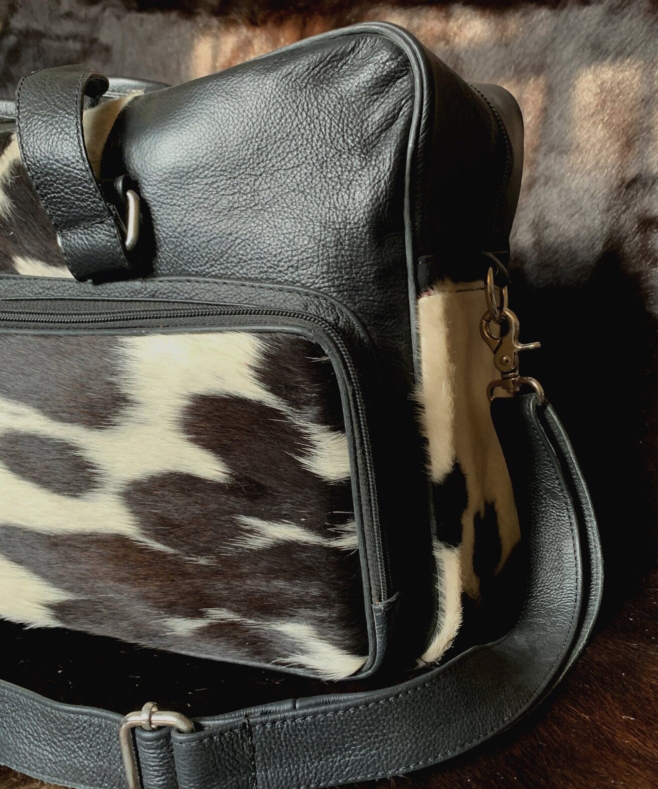 Indulge in the art of travel with this cow skin weekender bag, designed to carry you effortlessly from one adventure to the next.