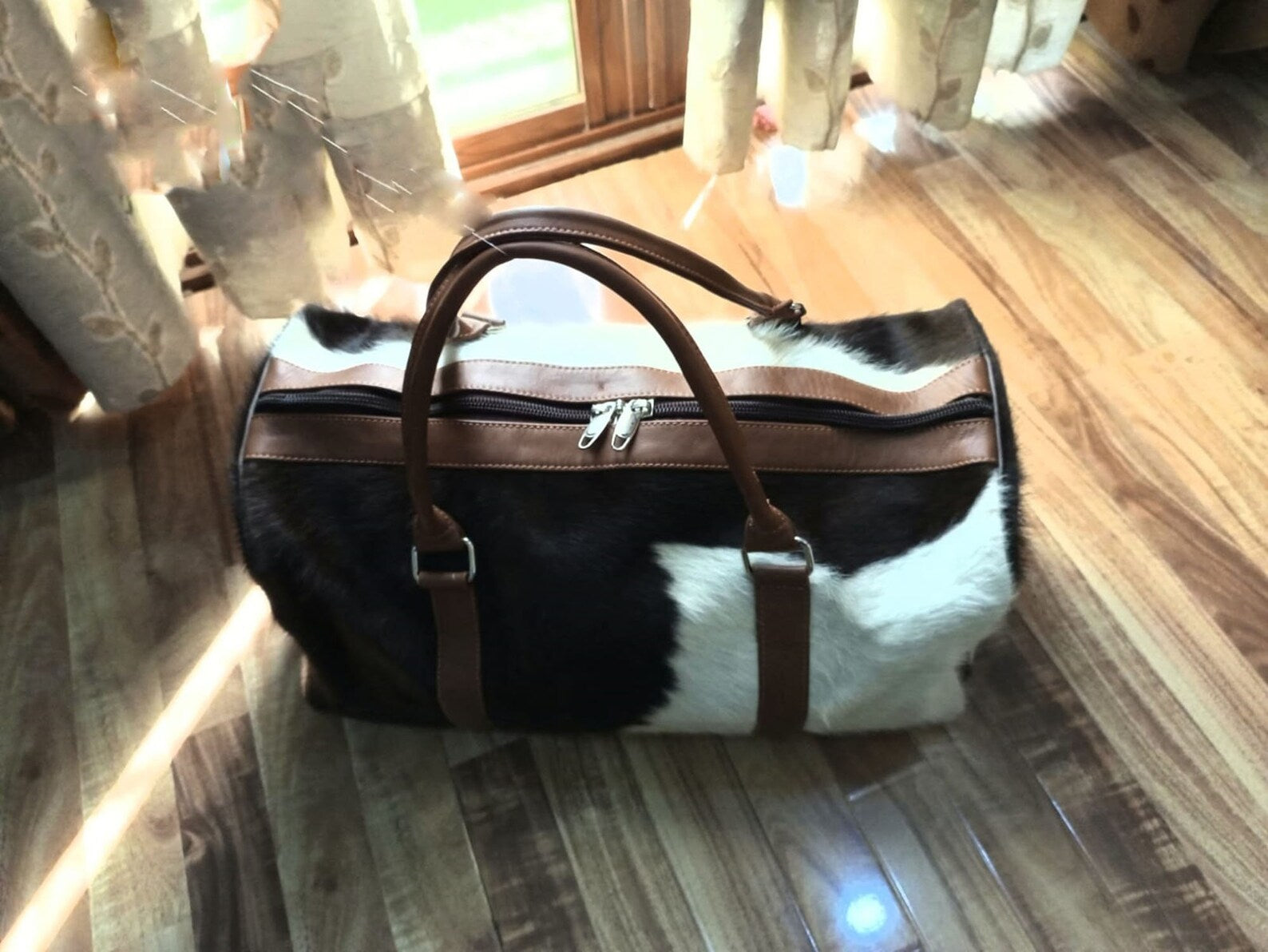 Make a statement with this cowhide overnight bag, your symbol of sophisticated travel.