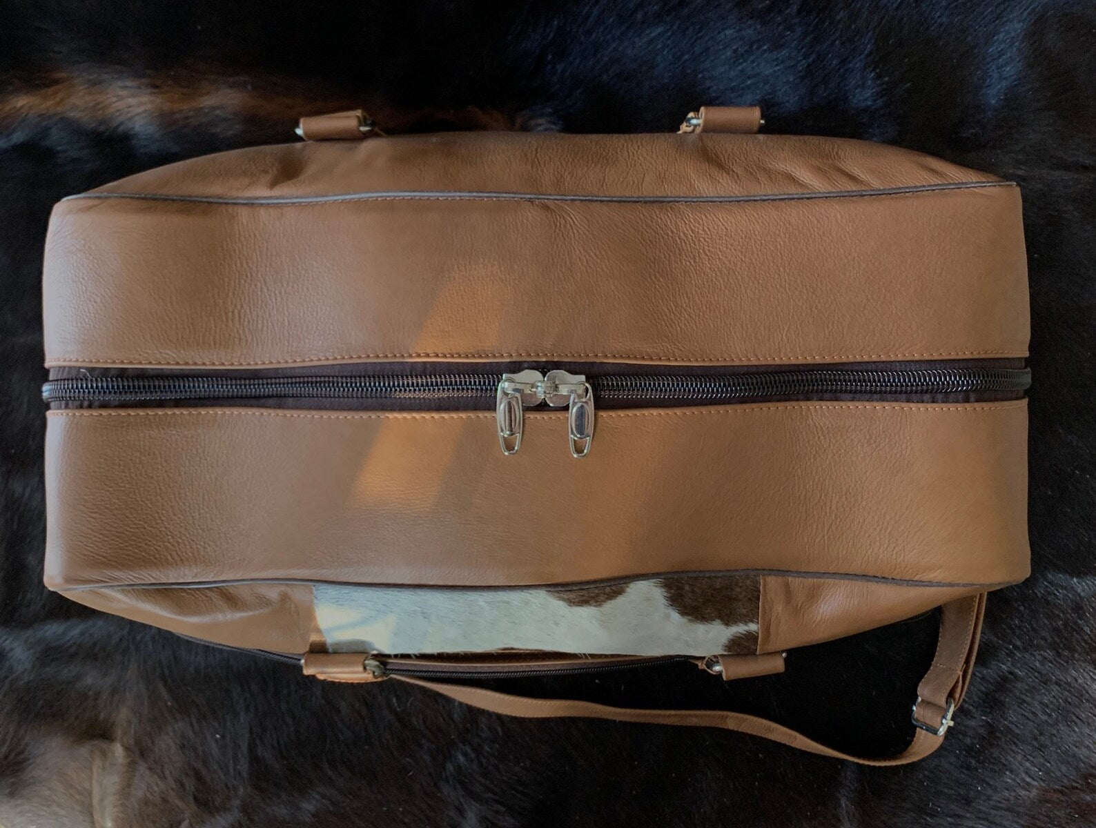 Hit the gym in style with this cow skin gym bag, a perfect blend of form and function for your active lifestyle.
