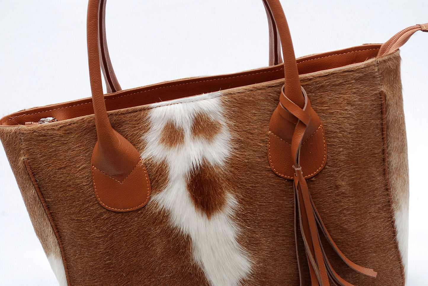You'll want to make sure the cowhide tote bag is large enough to fit all of your essentials, but not too big that it's cumbersome to carry.