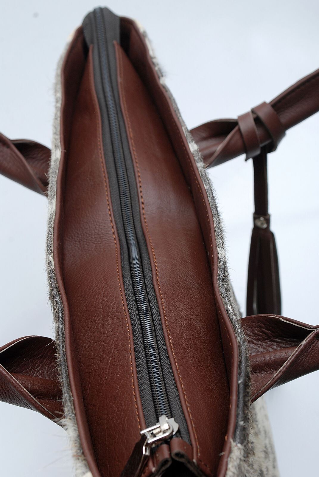 Combining practicality and durability with timeless aesthetic appeal, these cowhide bags are perfect for everyday use.