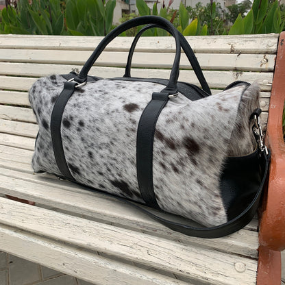 Command attention at the gym with this cow skin gym bag, designed to make a bold statement while keeping your essentials organized.
