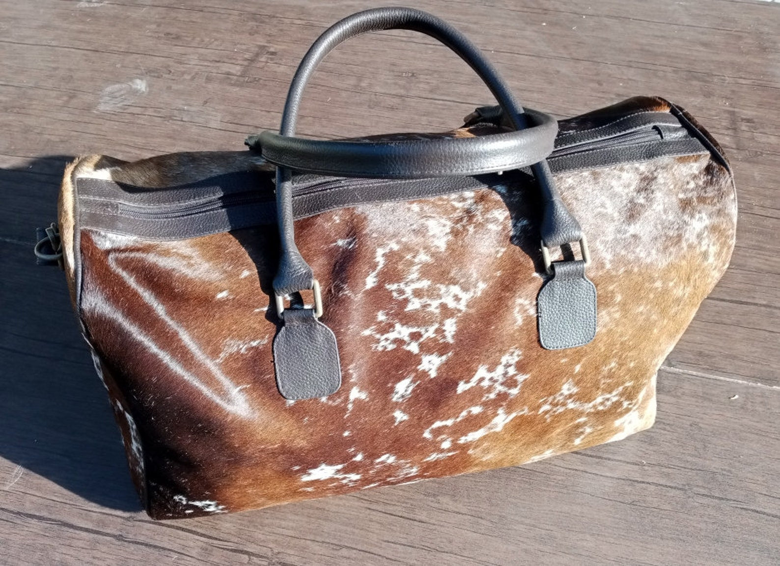 Venture forth with our cow skin travel bag, built to endure your journeys while ensuring your belongings stay safe and secure.