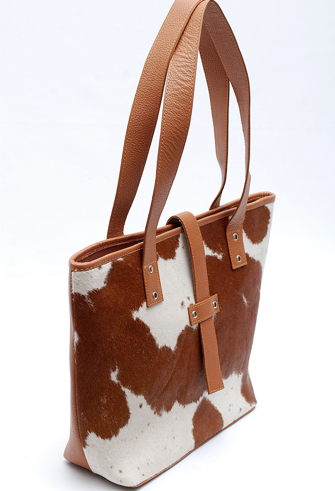 You can use a leather cowhide bucket bag for work, travel, or even as a diaper bag. They are large enough to hold all of your essentials, but not so big that they become cumbersome.