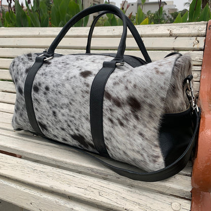 Travel in style with this cowhide duffle bag, a perfect blend of rugged charm and refined elegance for the intrepid explorer.