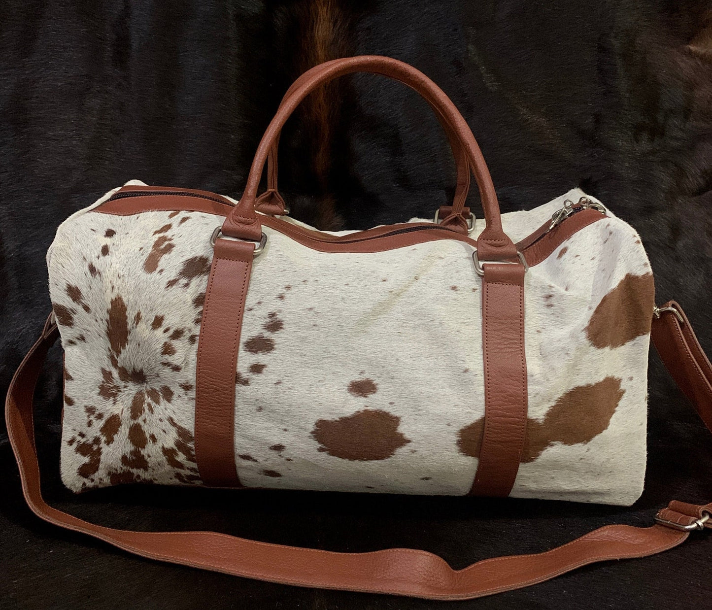 Indulge in the elegance of a cowhide weekender bag, your perfect companion for spontaneous getaways.