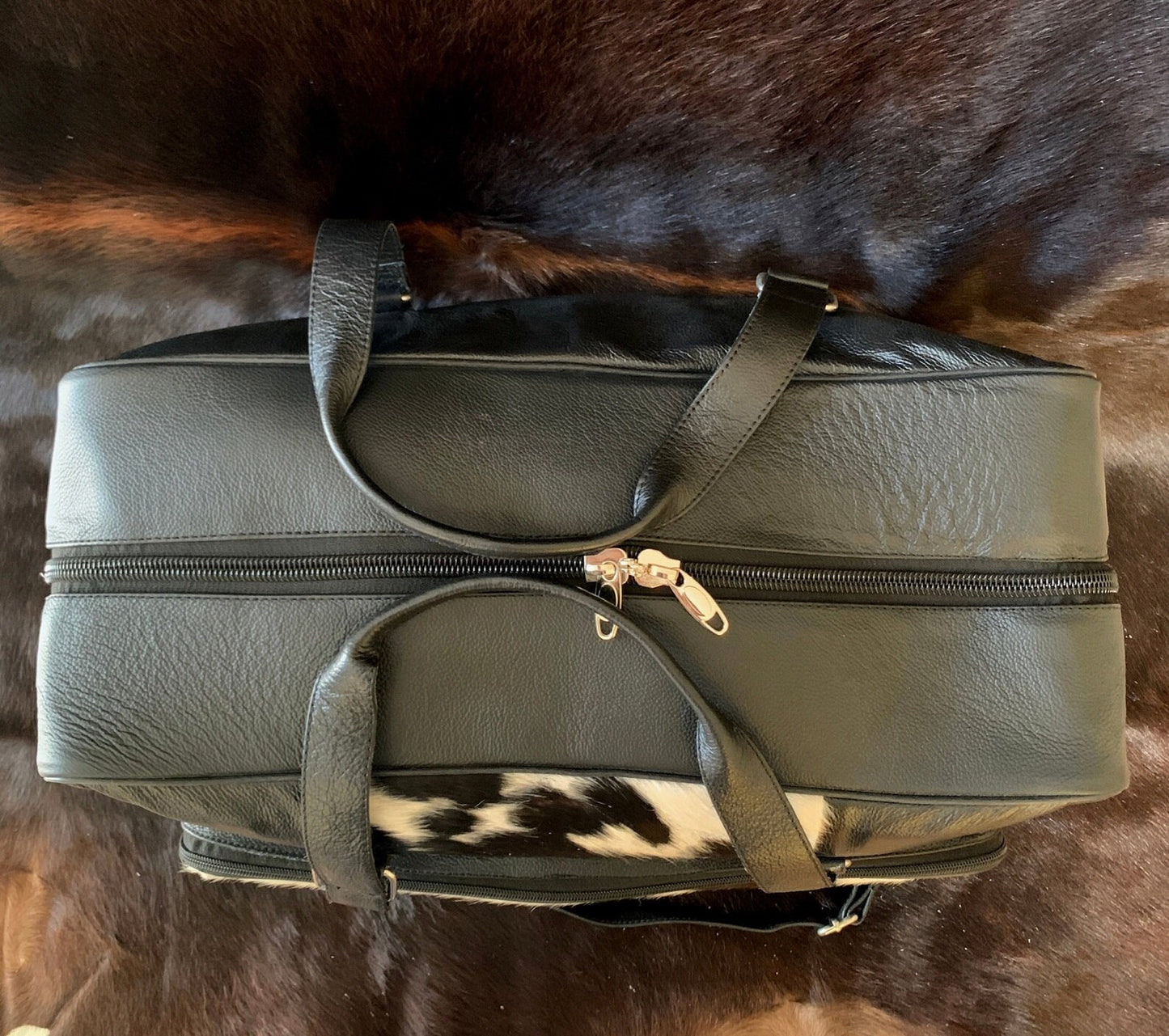 Conquer your workouts in style with this cowhide gym bag, blending form and function seamlessly for the active lifestyle.