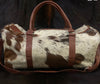 Unwind in style with this cowhide overnight bag, offering ample space for your essentials and more.