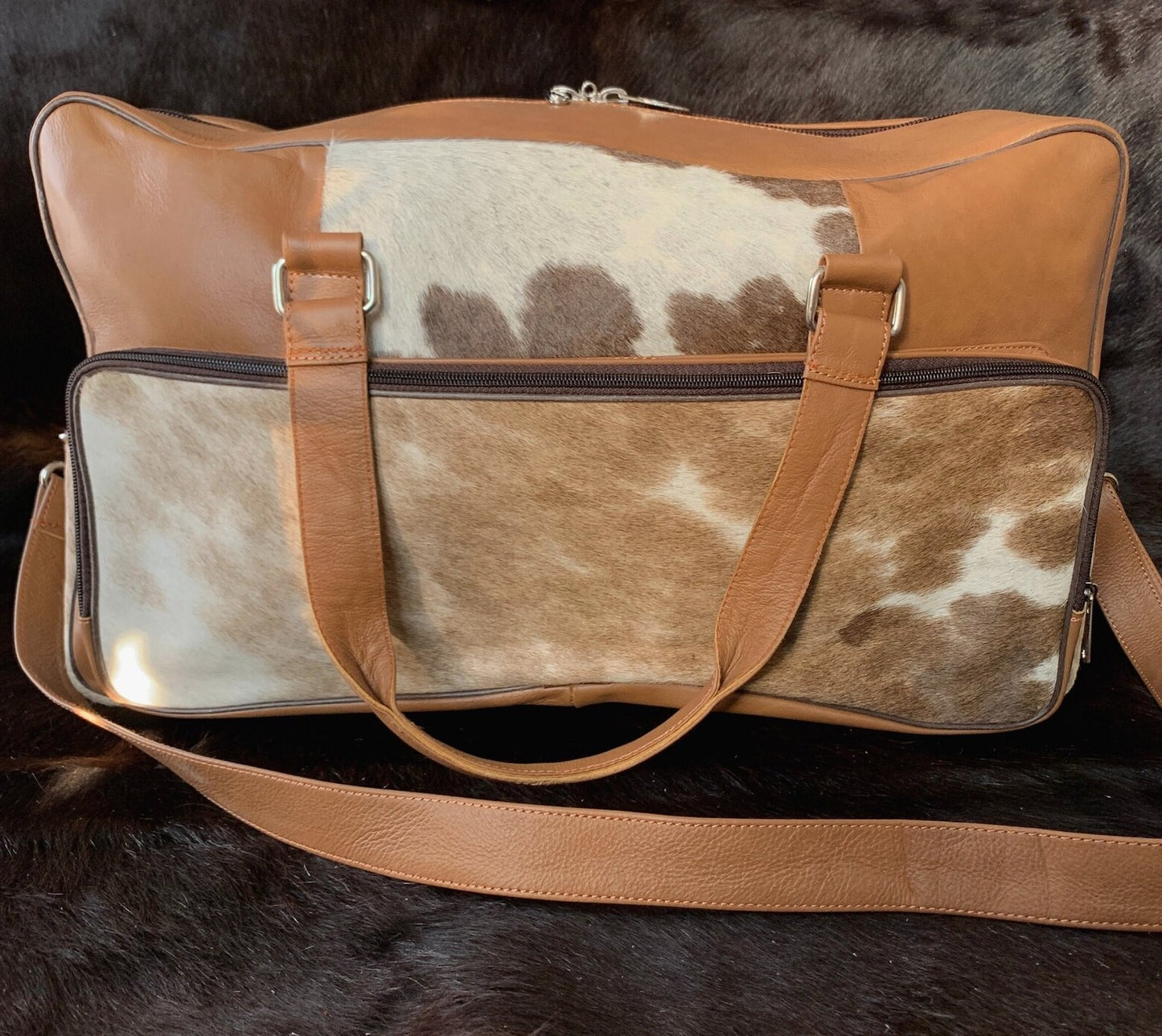 Escape in style with this cow skin weekender bag, a symbol of luxury and practicality for the modern traveler.