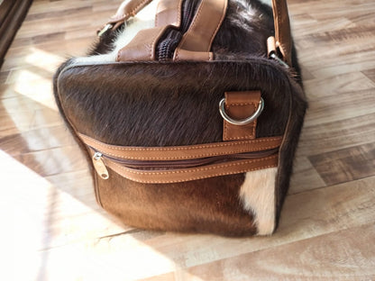 Travel in sophistication with this cow skin duffle bag, crafted to accompany you on your global adventures with style.