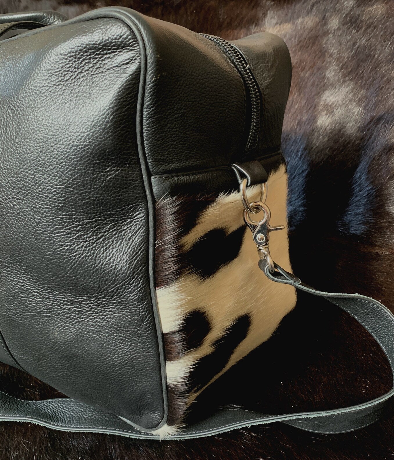 Embark on a luxurious travel experience with this cowhide travel bag, your trusted companion for journeys near and far.