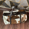 Hit the road with our dependable cowhide duffle bag. Adventure awaits.