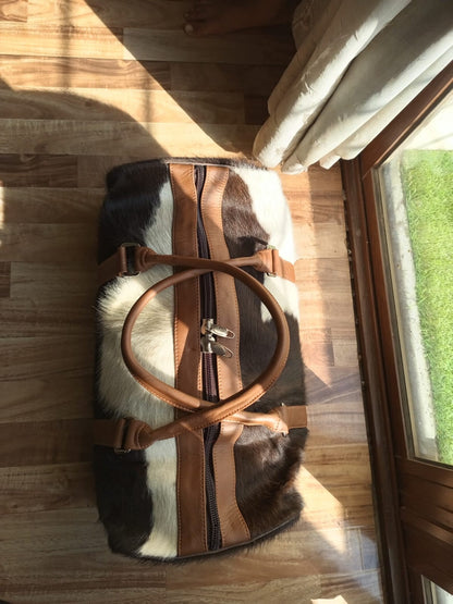 Experience the luxury of exploration with this cowhide weekender bag, your trusted companion for spontaneous getaways.