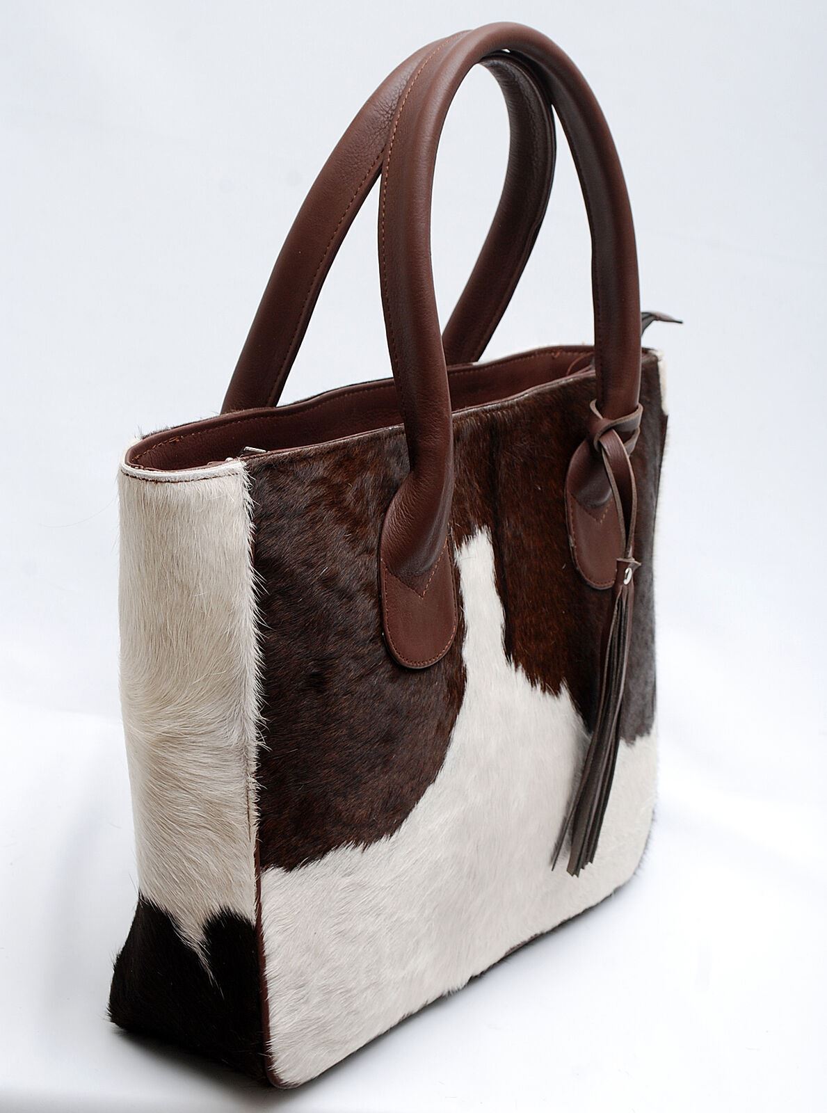 Whether you're carrying your laptop to work or taking a leisurely stroll through town, an attractive leather cowhide bag will make sure you look stylish while keeping all your essentials close at hand.