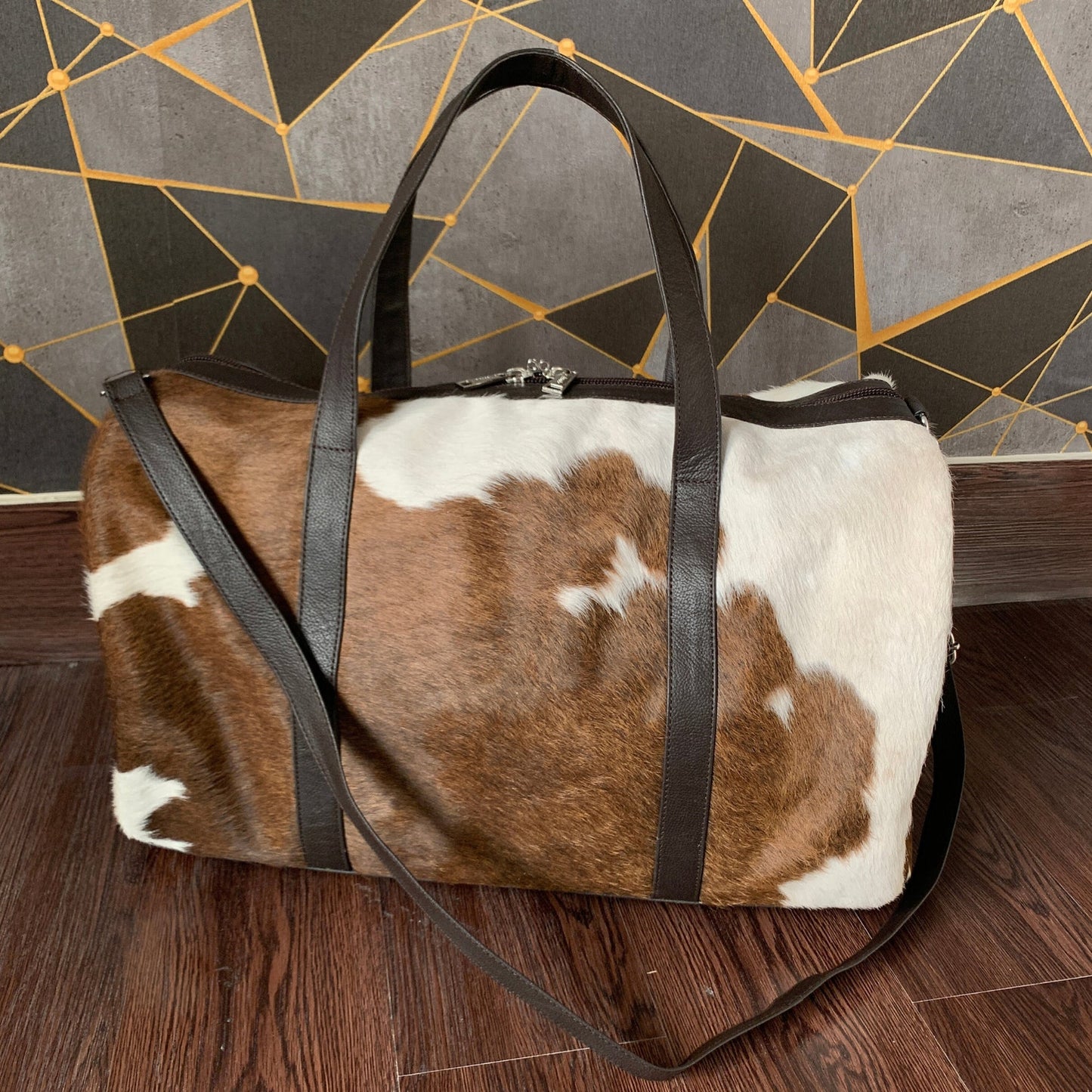  Pack smart with our versatile cowhide duffle bag. Functional choice.