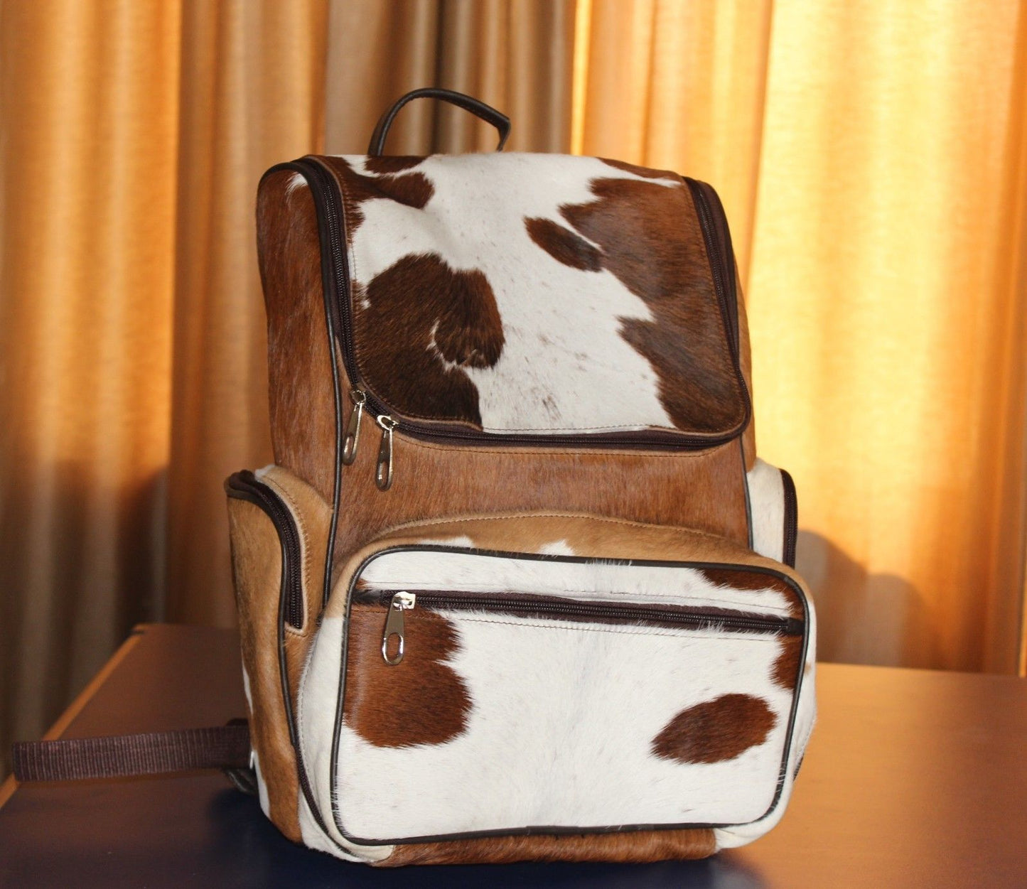 brown and white cow fur bag