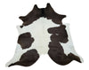 A country style living room can feature a brown white cowhide, it will impressive and chic.