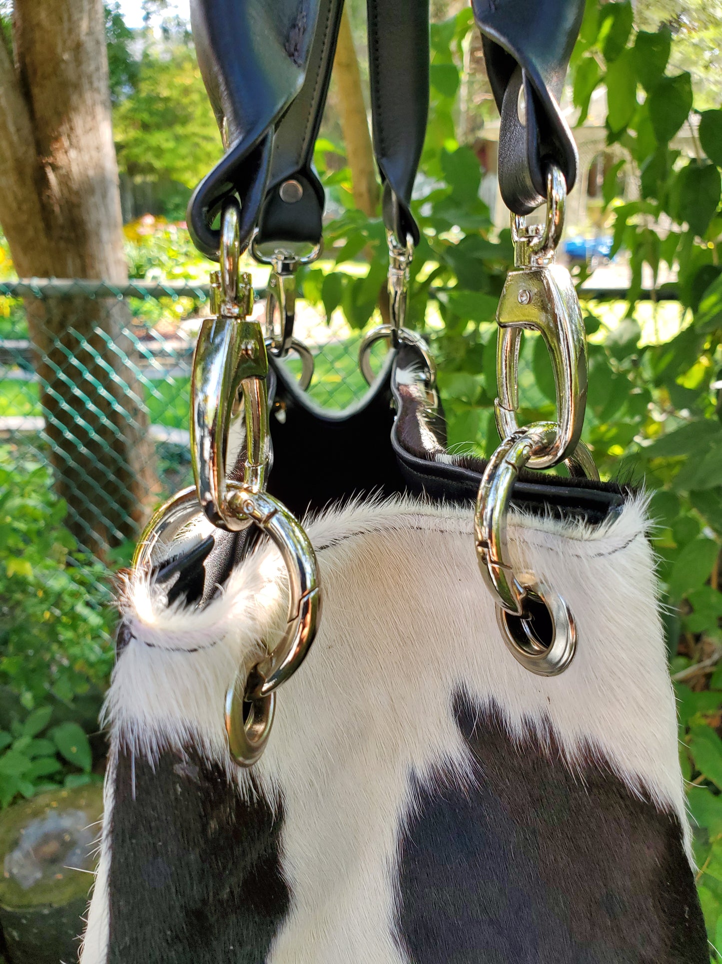 This shopping bag is made from real cowhide in black and white, perfect to carry your things.