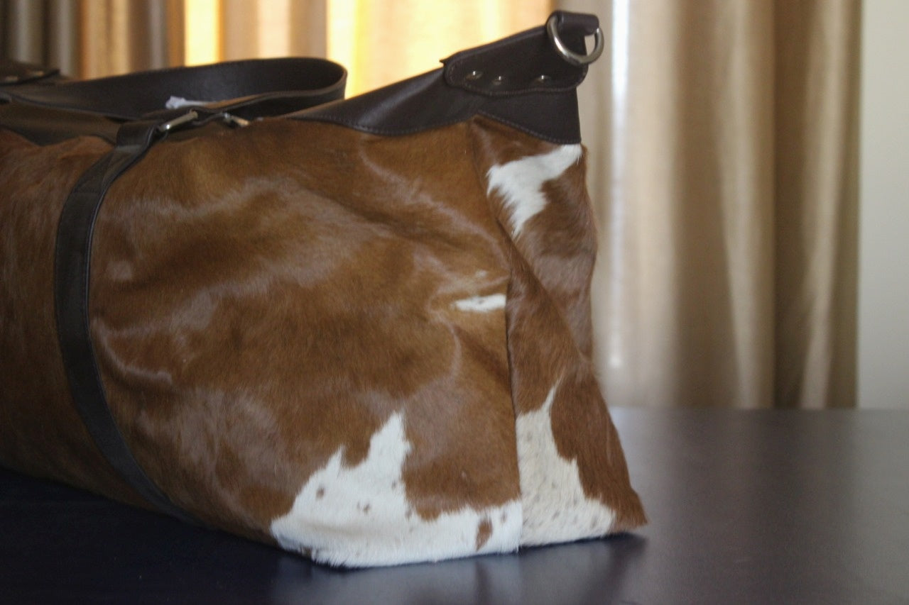Travel in luxury with this cow skin weekender bag, designed to meet the demands of your jet-setting lifestyle.