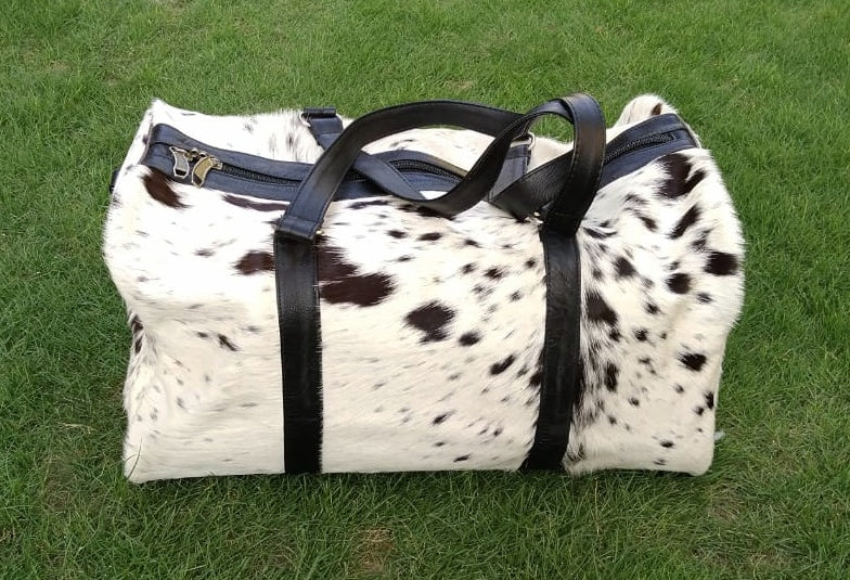 Pack efficiently with our cowhide weekender bag, offering durability and space for your travel essentials.