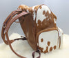 A natural cowhide backpack is made for mommies who love shopping, this southern style bag is made from real fur in speckled brown and white.