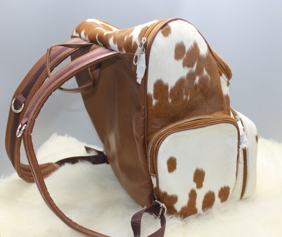 A natural cowhide backpack is made for mommies who love shopping, this southern style bag is made from real fur in speckled brown and white.