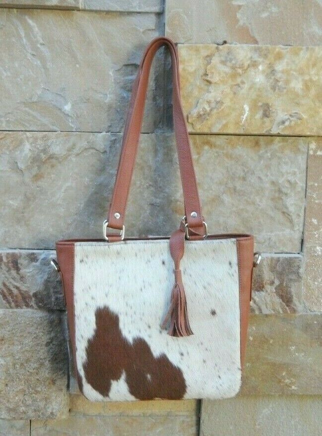 With time our cowhide handbags get better and better as the leather softens and deepens in color.
