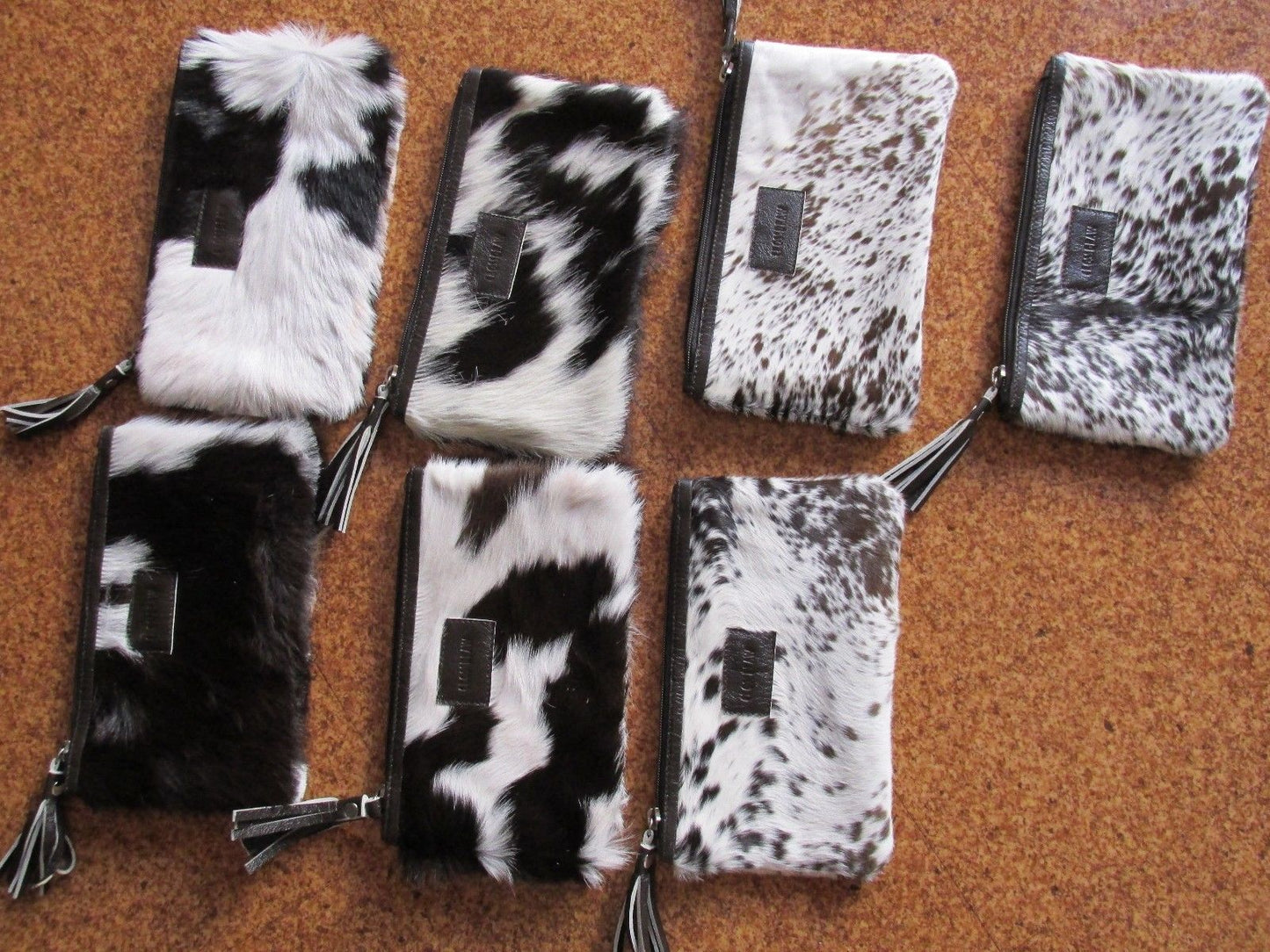 brown and white cowhide fur purse