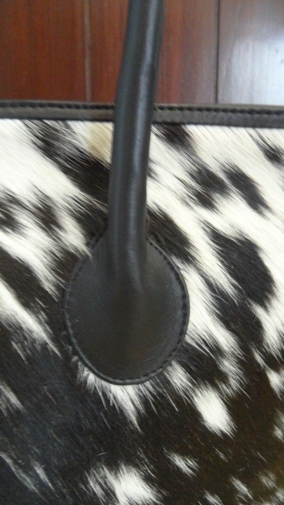 If you are looking for a new cowhide bag to take your style up a notch, consider investing in a black and white leather tote bag. You won't regret it!